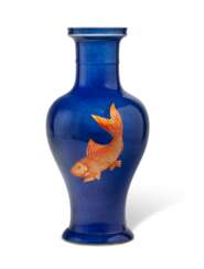 AN IRON-RED-DECORATED POWDER-BLUE GROUND BALUSTER VASE
