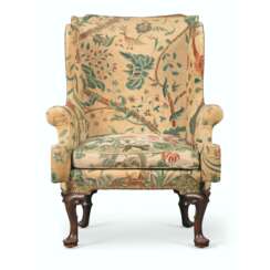 AN ENGLISH MAHOGANY AND CREWELWORK WING ARMCHAIR