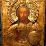 Старинная икона Спасителя в тяжелом кованом окладе из серебра 