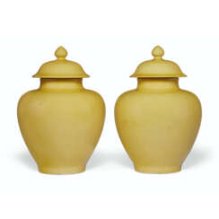 A PAIR OF YELLOW-GLAZED JARS AND COVERS
