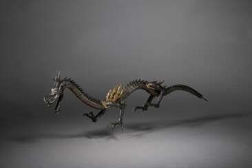 A SILVER ARTICULATED SCULPTURE OF A DRAGON
