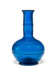 A BLUE GLASS BOTTLE VASE