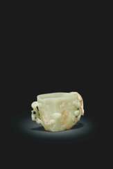 A FINELY CARVED GREENISH-YELLOW JADE CUP