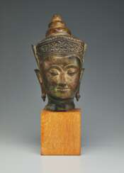 A GILT-BRONZE HEAD OF BUDDHA