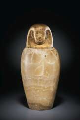 AN EGYPTIAN ALABASTER CANOPIC JAR