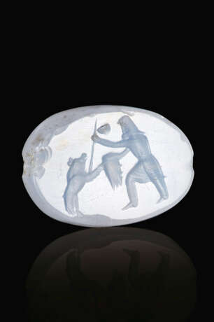 A GRECO-PERSIAN BLUE CHALCEDONY SCARABOID WITH A PERSIAN HUNTER SPEARING A BOAR - photo 1