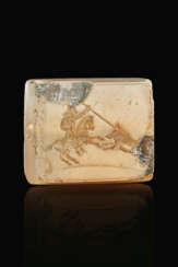 A GRECO-PERSIAN BROWN CHALCEDONY TABLOID WITH A PERSIAN HORSEMAN SPEARING A BOAR