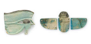 AN EGYPTIAN FAIENCE WADJET-EYE AMULET AND A WINGED SCARAB