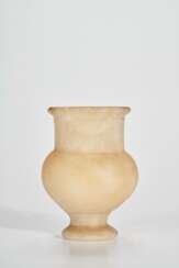 AN EGYPTIAN ALABASTER FOOTED JAR