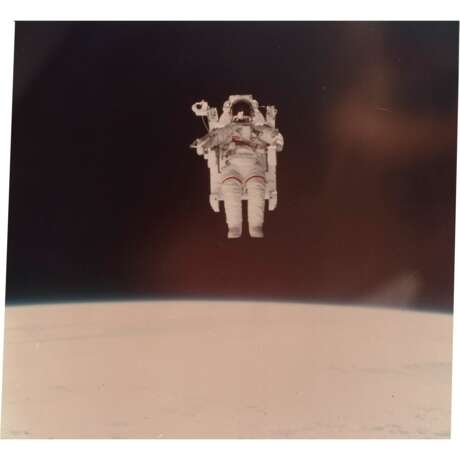 THE FIRST UNTETHERED SPACE FLIGHT: ASTRONAUT BRUCE MCCANDLESS II USING THE MANNED MANOEUVERING UNIT IN SPACE - photo 1