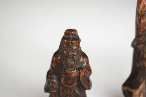 Vier Netsuke aus Holz: Hotei, Kwanju, Maske der Okame und Sennin mit Resten von polychromer Fassung - photo 7