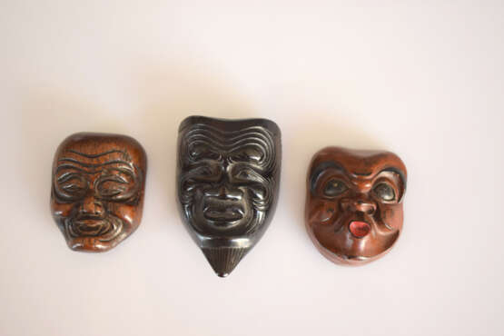 Drei Masken-Netsuke von Hyottoko, Okina und eines Greisen aus verschiedenen Hölzern, teilweise lackiert - Foto 2
