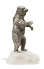 Silver figurine of a standing bear mounted on mountain crystal