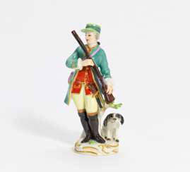 Porcelain figurine of hunter with musket and dog