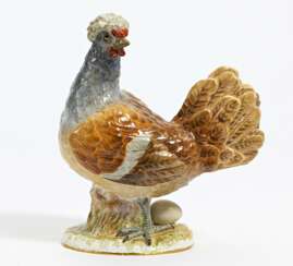 Porcelain figurine of crested chicken with egg