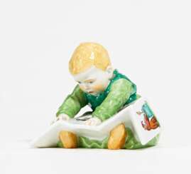 Porcelain figurine of child with storybook