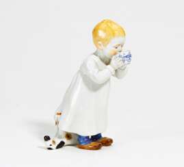 Porcelain figurine of boy with milk bowl