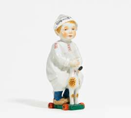 Porcelain figurine of boy riding a wooden horse