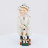 Porcelain figurine of boy riding a wooden horse - photo 2