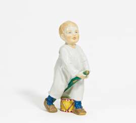 Porcelain figurine of boy with drumstick and drum