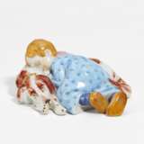 Porcelain figurine of child lying on dog - photo 1