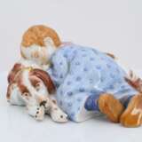 Porcelain figurine of child lying on dog - photo 2