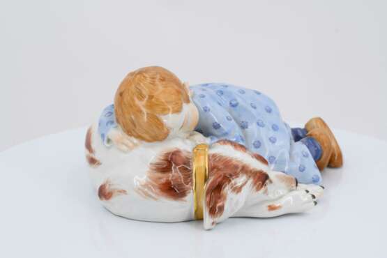 Porcelain figurine of child lying on dog - photo 3