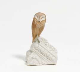 Little porcelain barn owl on architecture