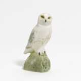 Small porcelain figurine of an arctic owl on rock - photo 1