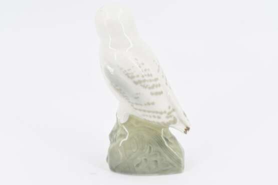 Small porcelain figurine of an arctic owl on rock - photo 4