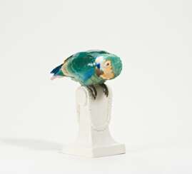 Porcelain parrot on base with garland