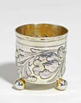 Small silver beaker with spheric feet and flower tendrils