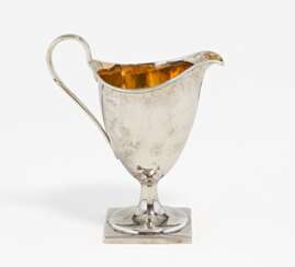 Footed silver milk jug