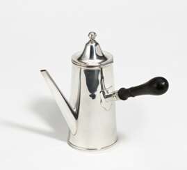 Silver coffee pot with side handle and sleek body