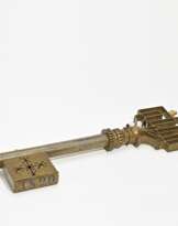 Iron and brass shop sign in the shape of a key