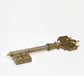 Iron and brass shop sign in the shape of a key