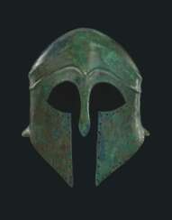 A GREEK BRONZE HELMET OF CORINTHIAN TYPE