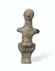 A VINCA TERRACOTTA STANDING MALE FIGURE