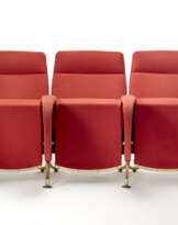 A row of three folding armchairs