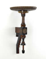 Shelf with large circular top covered in leather and copper foil embossed with flowers and stars, perforated with geometric motifs