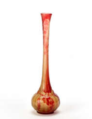 Vase with a globular body and narrow elongated neck in acid-etched cameo glass with floral decorations in red / orange on a transparent yellow background