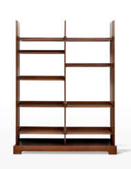 Bookcase in solid teak wood, edged and veneered, composed of three lamellar uprights, a monolithic base and nine movable shelves