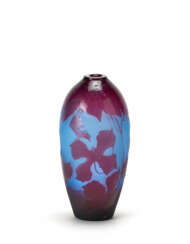 Acid-etched cameo glass vase with floral decorations in marc on a blue background