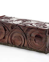 Solid wood chest of drawers decorated in carving with abstract circular and linear motifs, base covered in metal with linear embossed decorations