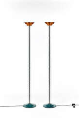 Pair of floor lamps of post-modern taste, with green painted metal base, cylindrical stem in colorless transparent glass, diffuser cup in bronze-colored satin metal