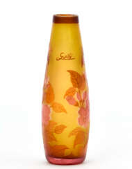 Acid-etched cameo glass vase in shades of amber and decorated with a floral motif in shades of red and pink