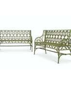 Coalbrookdale Foundry. A PAIR OF FRENCH GOTHIC REVIVAL GREEN-PAINTED CAST-IRON GARDEN BENCHES
