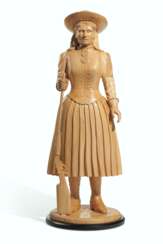 A CARVED MAPLE TOBACCO FIGURE OF ANNIE OAKLEY
