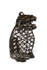 A LARGE BRONZE RETICULATED BEAST-FORM LANTERN
