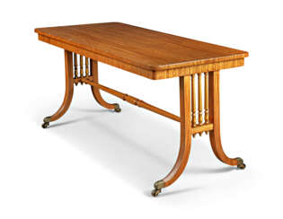 A REGENCY EAST INDIAN SATINWOOD AND PARCEL-GILT LIBRARY TABLE